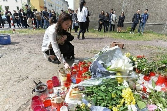 有学生在悼念会上献花。