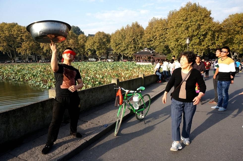 西湖断桥"脸盆哥"逗乐游人(1/6)